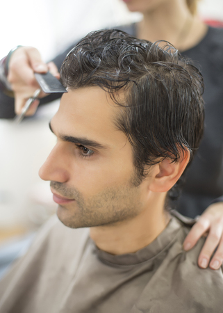 Young man at hairdresserの写真素材
