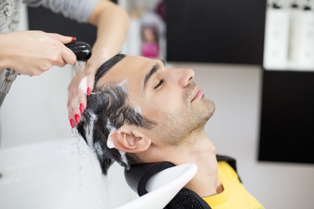 Young man at hairdresserの写真素材