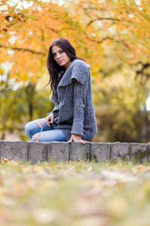 Young woman in the autumn parkの写真素材