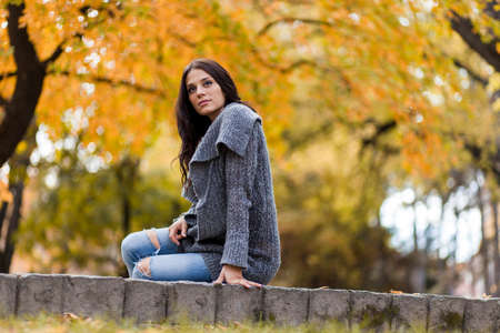 Young woman in the autumn parkの写真素材