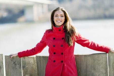 Pretty young woman in red coatの写真素材