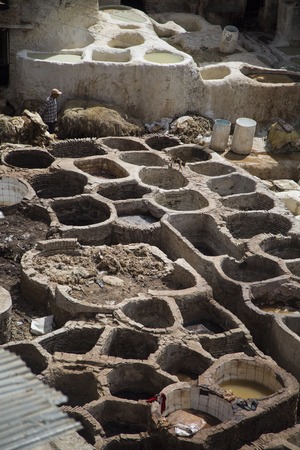 FES, MOROCCO - SEPTEMBER 15, 2014: Unidentified man working at tannery in Fes, Morocco. This is the oldest leather tannery in the world and has not changed since the 11th century.のeditorial素材