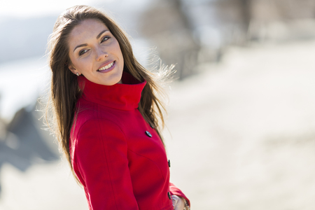 Pretty young woman in red coatの写真素材
