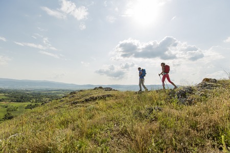 Young couple hiking on the mountainの写真素材