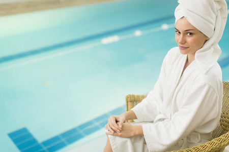 Pretty young woman by the poolの写真素材