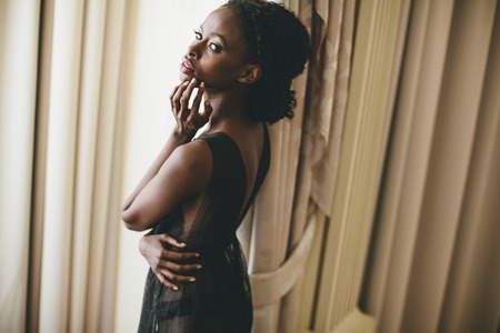 Young black woman in the roomの写真素材