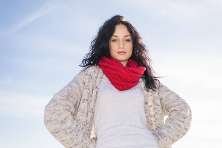 Cute young woman at the beach at winterの写真素材
