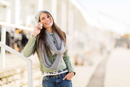 Young woman with mobile phone in the parkの写真素材