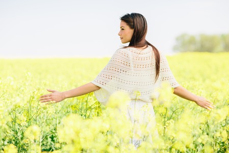 Young woman in the spring fieldの写真素材