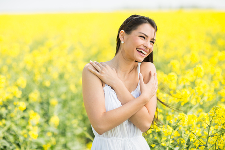 Young woman in the spring fieldの写真素材