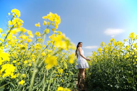 Young woman in the spring fieldの写真素材