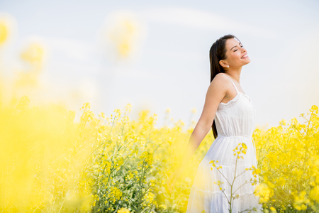 Young woman in the spring fieldの写真素材