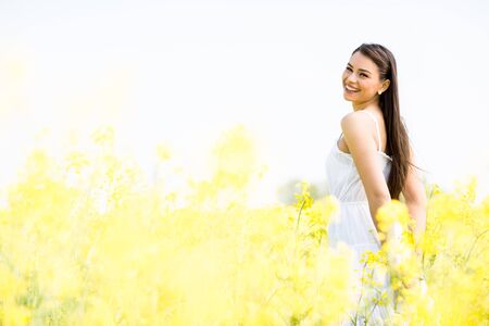 Young woman in the spring fieldの写真素材