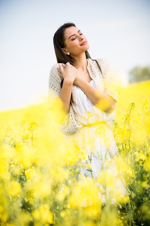 Young woman in the spring fieldの写真素材
