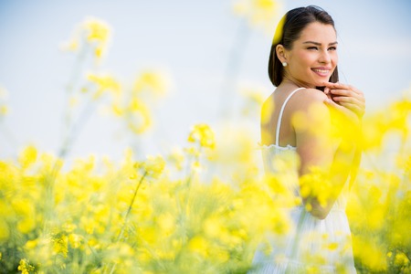 Young woman in the spring fieldの写真素材