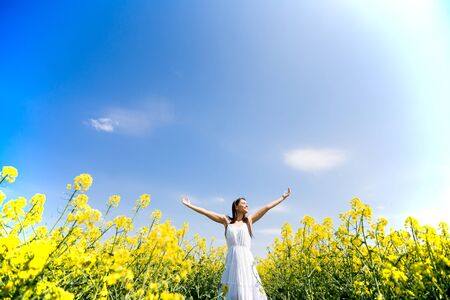 Young woman in the spring fieldの写真素材