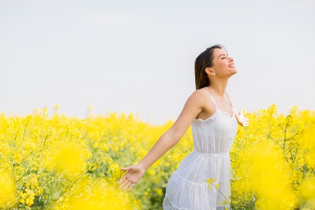 Young woman in the spring fieldの写真素材