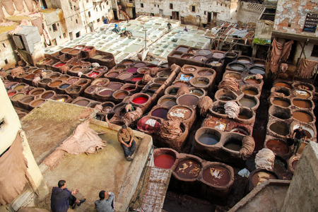 FES, MOROCCO - DECEMBER 12, 2014: Unidentified people working at tannery in Fes, Morocco. This is the oldest leather tannery in the world and has not changed since the 11th century.のeditorial素材
