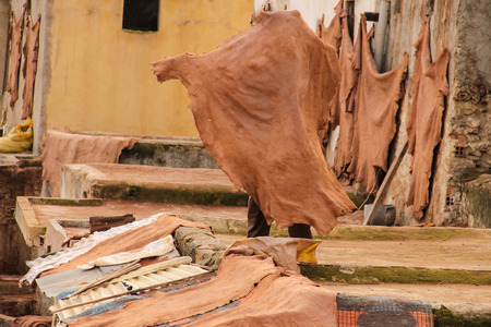 FES, MOROCCO - DECEMBER 12, 2014: Unidentified man working at tannery in Fes, Morocco. This is the oldest leather tannery in the world and has not changed since the 11th century.のeditorial素材