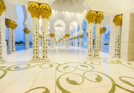 ABU DHABI, UAE - MAY 4, 2015: Unidentified people at Sheikh Zayed Mosque in Abu Dhabi. Mosque was designed by Yusef Abdelki and opened at 2007.のeditorial素材