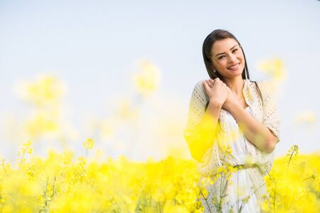 Young woman in the spring field