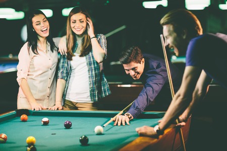 Young people playing poolの写真素材