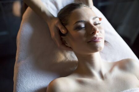 Pretty young woman having a facial massage