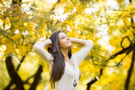 Young woman in autumn forestの写真素材