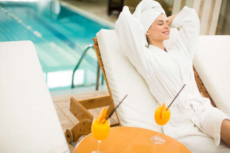 Pretty young woman by the poolの写真素材