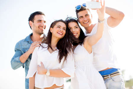Young people taking photo on the beach