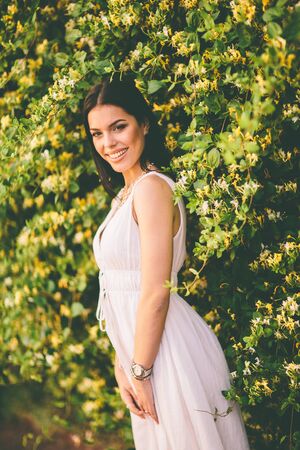 Young woman by the wallの写真素材