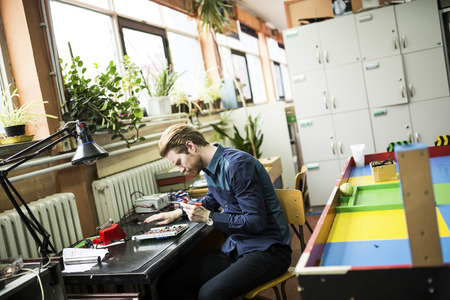 Young man in electronics workshop