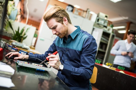 Young man in electronics workshop