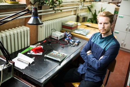 Young man in electronics workshop