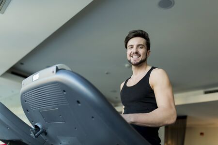 Young man training in the gymの写真素材
