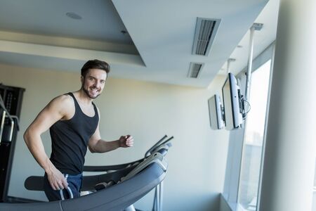 Young man training in the gymの写真素材
