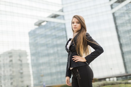Young business woman in front of office buildingの写真素材