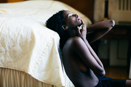 Young black woman in the roomの写真素材