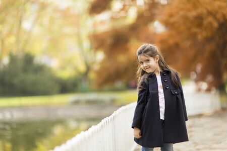 Little girl in the autumn parkの写真素材