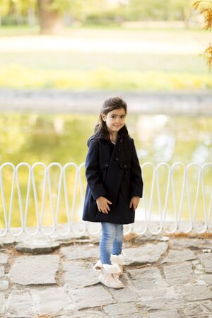 Little girl in the autumn parkの写真素材