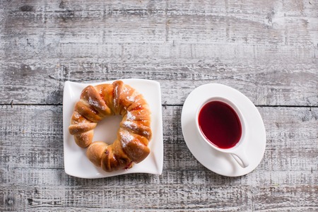 Cup of fruit tea with croissantの写真素材