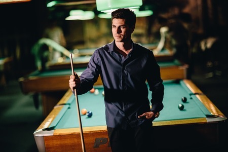 Young man playing pool