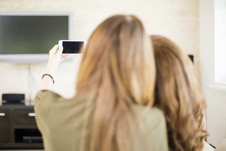 Young women taking selfie in the  roomの写真素材