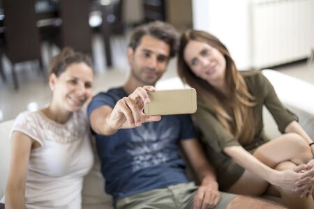 Young people taking selfie in the room
