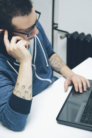 Young man working on a laptopの写真素材