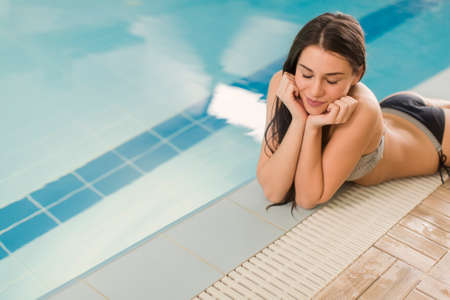 Pretty young woman by the pool