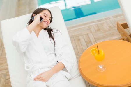 Pretty young woman by the poolの写真素材