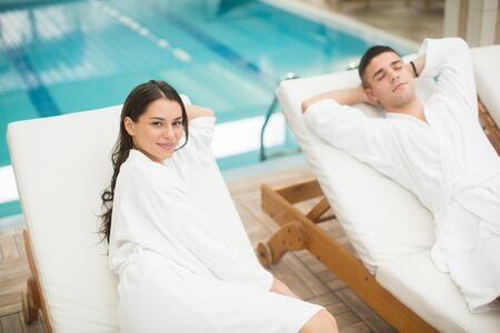Young couple relaxing by the poolの写真素材