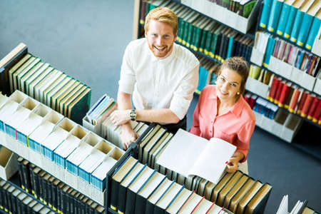 Young woman and man in the library
