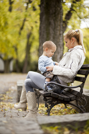 Mother and son in the autumn forestの写真素材